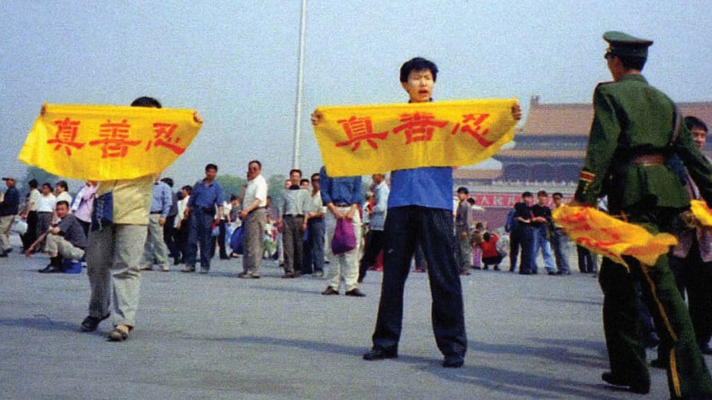 Des pratiquants de Falun Gong lancent un appel sur la place Tiananmen avec des banderoles portant les caractères : 真 Vérité, 善 Bonté, 忍 Patience, les principes fondamentaux de l'enseignement du Falun Gong.
